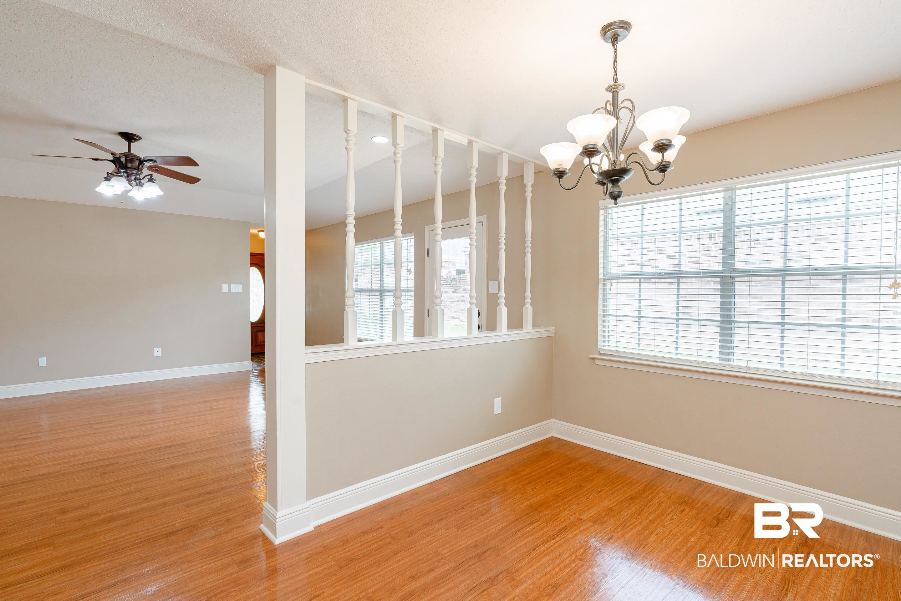 23 Old Mill Court Mobile, AL 36608 - Photo 10 of 37 Empty room with ceiling fan with notable chandelier and light wood-type flooring
