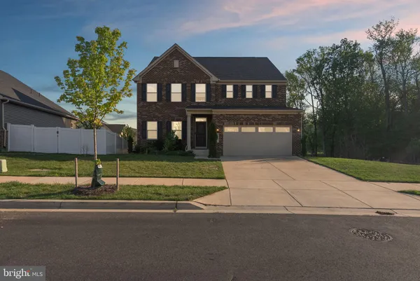 a front view of a house with a garden and a yard