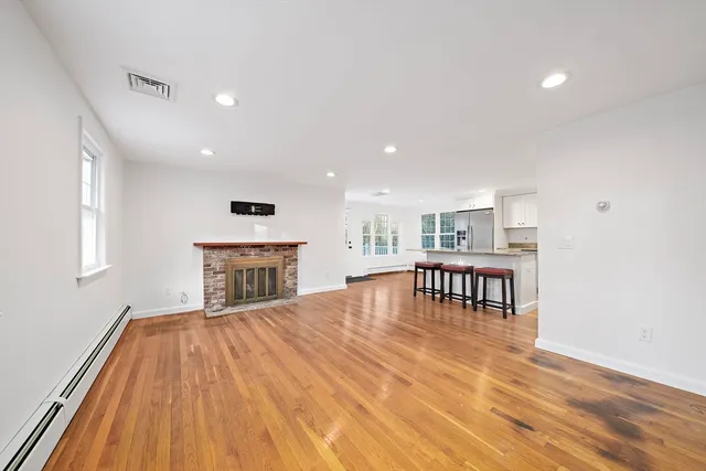 a view of livingroom with furniture fireplace and window