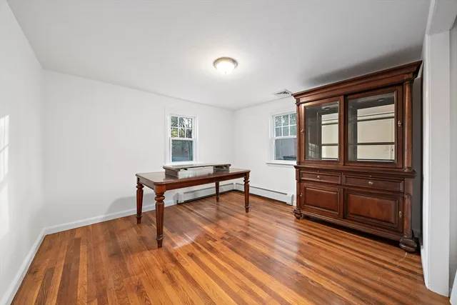 a room with wooden floors and furniture