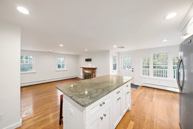 a spacious bathroom with a granite countertop sink and a large mirror