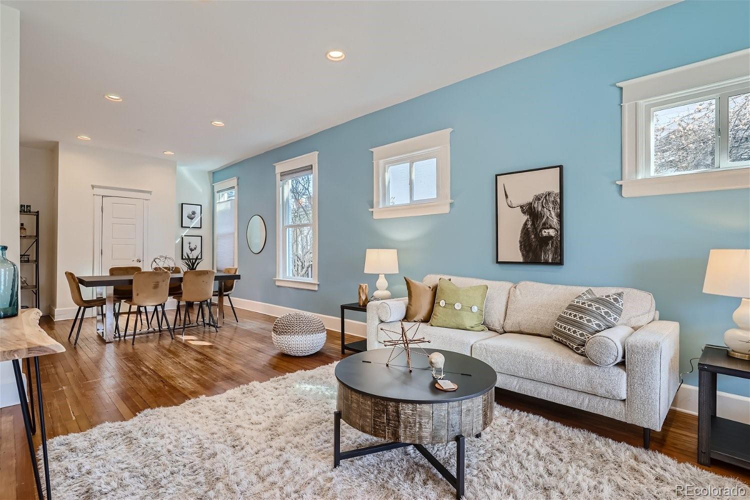 1516 Cook Street Denver, CO 80206 - Photo 1 of 35 a living room with furniture and a wooden floor