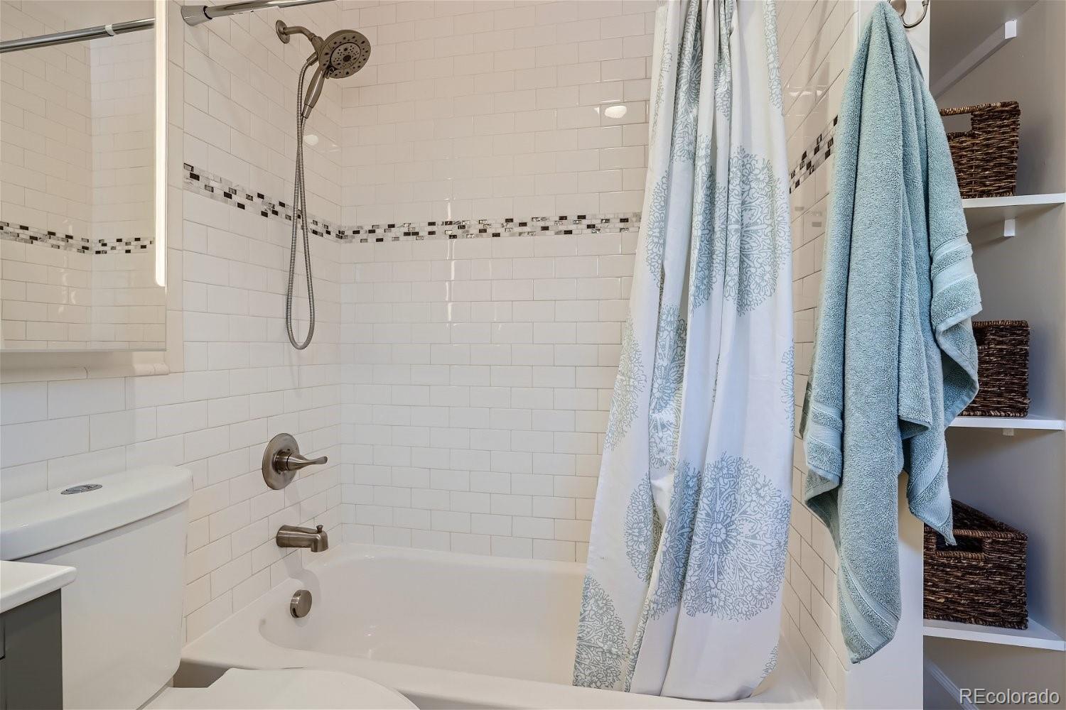 1516 Cook Street Denver, CO 80206 - Photo 17 of 35 a bathroom with a bathtub and a shower