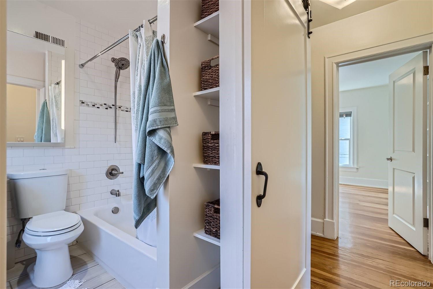 1516 Cook Street Denver, CO 80206 - Photo 18 of 35 a bathroom with a toilet sink and shower