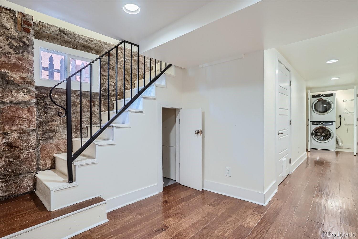 1516 Cook Street Denver, CO 80206 - Photo 21 of 35 a view of entryway with stairs and wooden floor