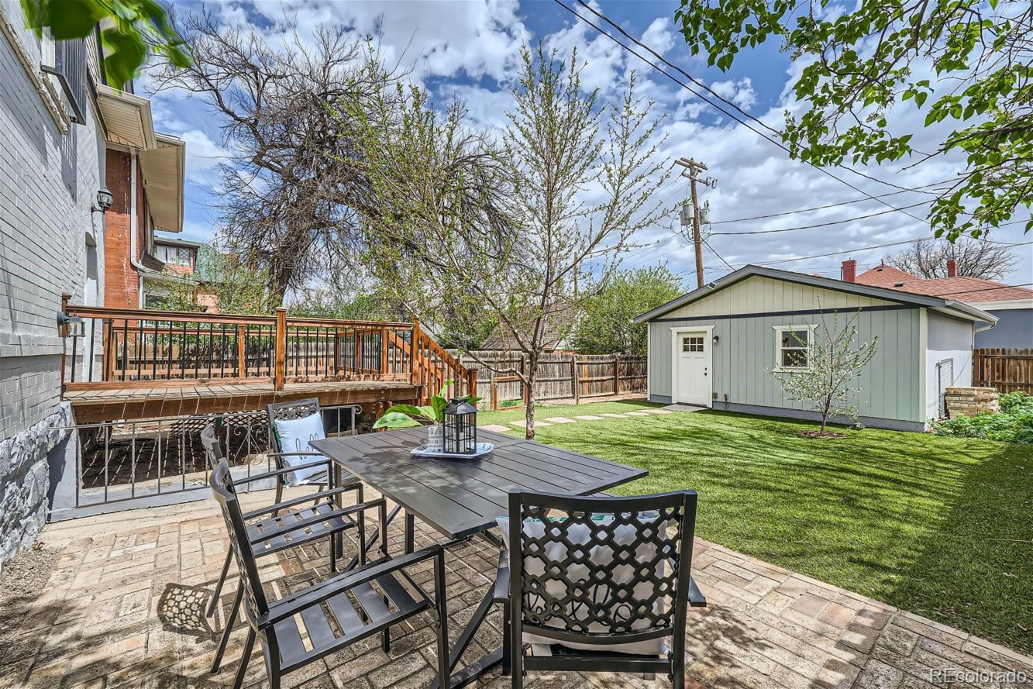 1516 Cook Street Denver, CO 80206 - Photo 29 of 35 a backyard of a house with table and chairs