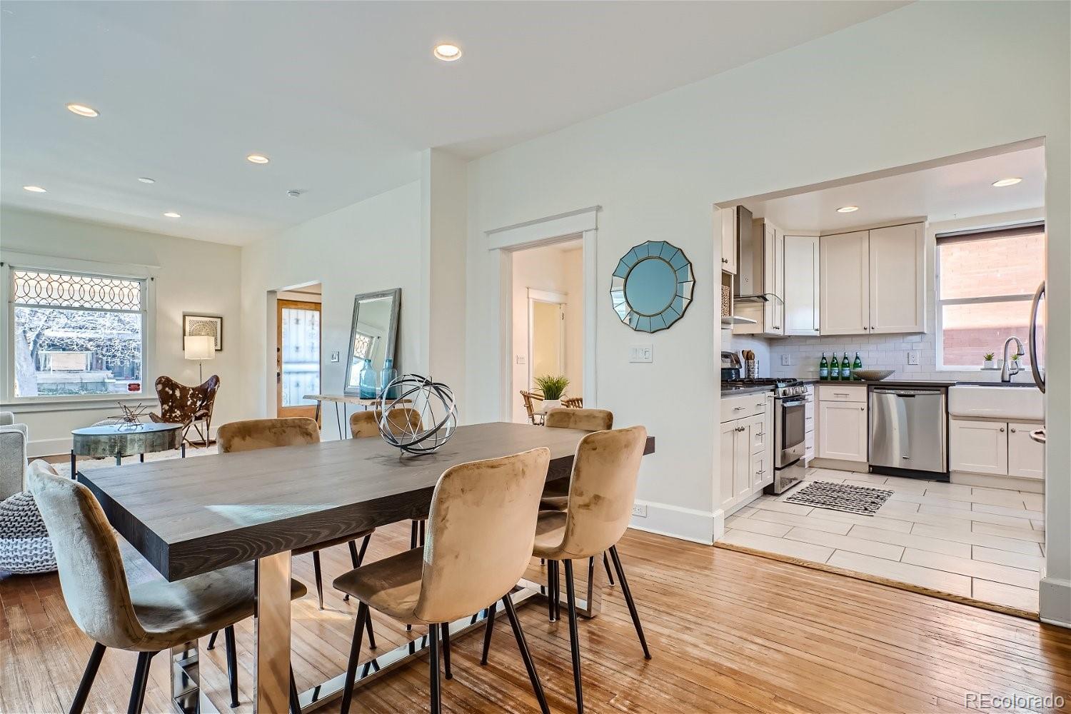 1516 Cook Street Denver, CO 80206 - Photo 3 of 35 a view of a dining room with furniture and wooden floor