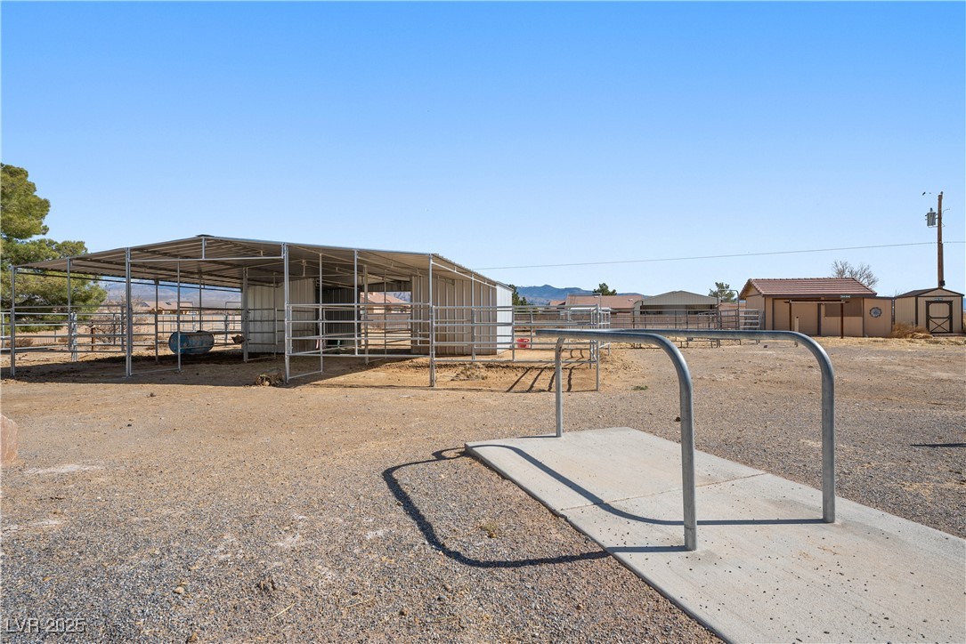 3581 Ranger Way Pahrump, NV 89048 - Photo 15 of 57 View of yard featuring an exterior structure and an outdoor structure