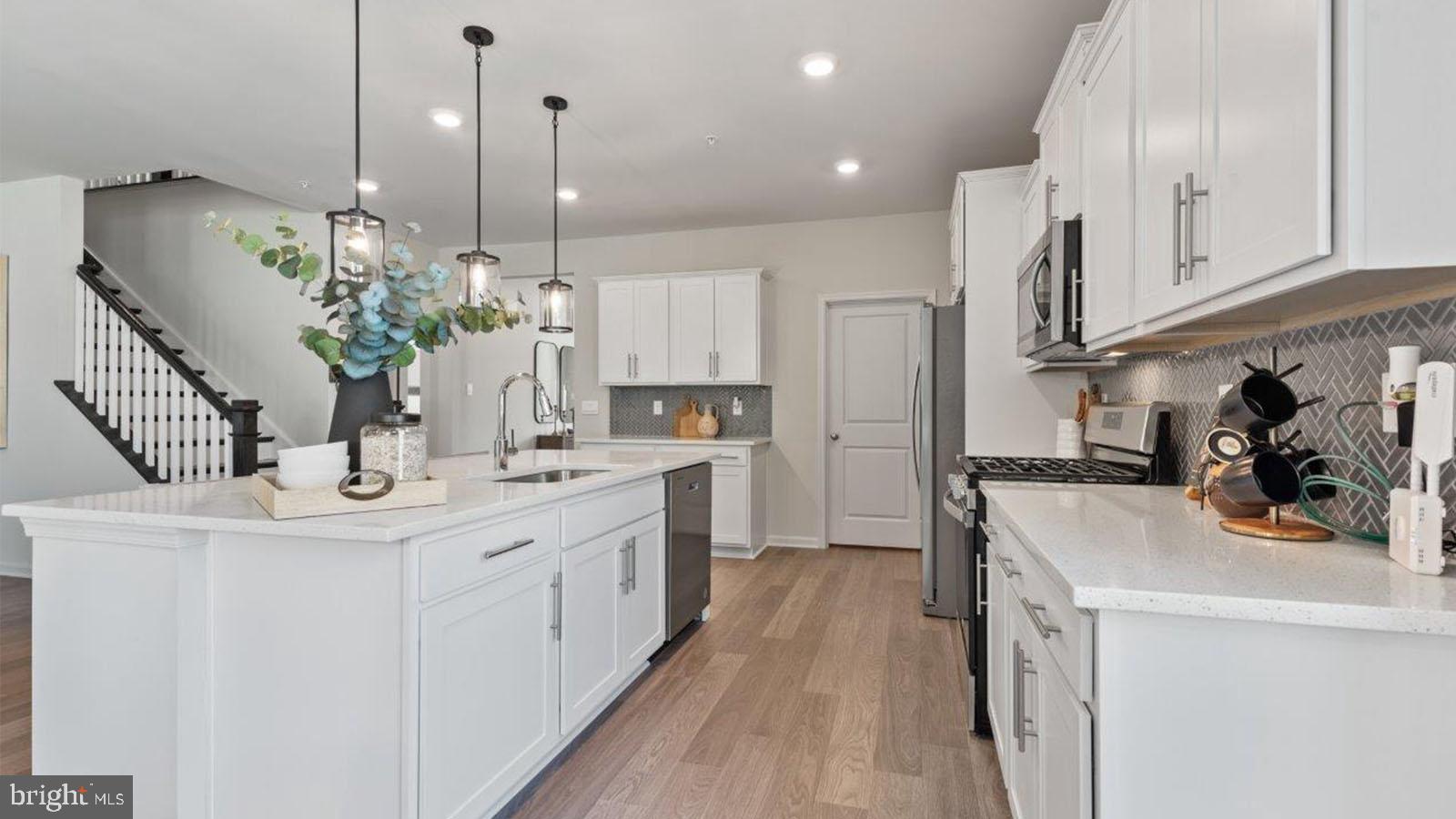 2 Comes Rdg Court Rosedale, MD 21237 - Photo 5 of 29 a kitchen with kitchen island a sink appliances and cabinets