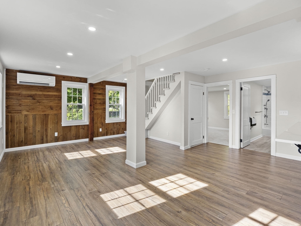 210 John Dyer Road Little Compton, RI 02837 - Photo 11 of 42 a view of an empty room with wooden floor and a window