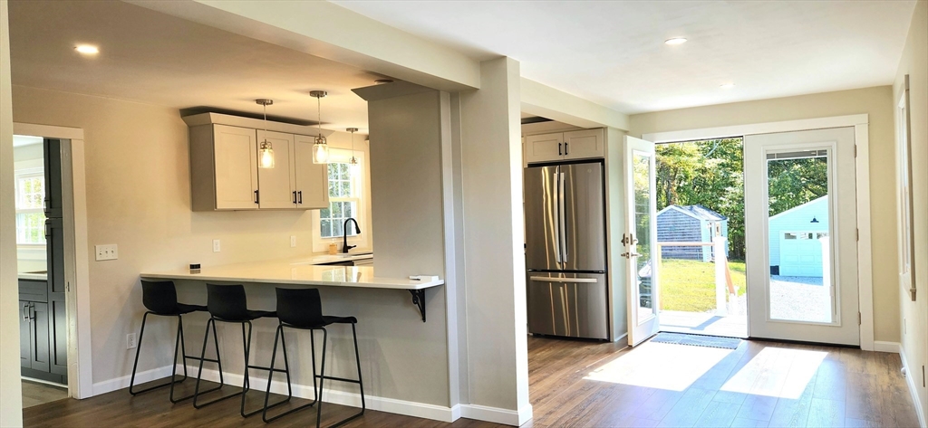 210 John Dyer Road Little Compton, RI 02837 - Photo 40 of 42 a view of a hallway with wooden floor and glass door