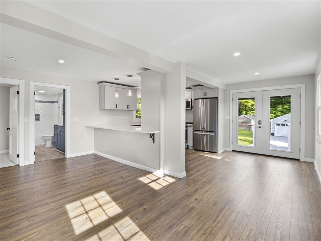 210 John Dyer Road Little Compton, RI 02837 - Photo 5 of 42 a view of empty room with wooden floor and windows