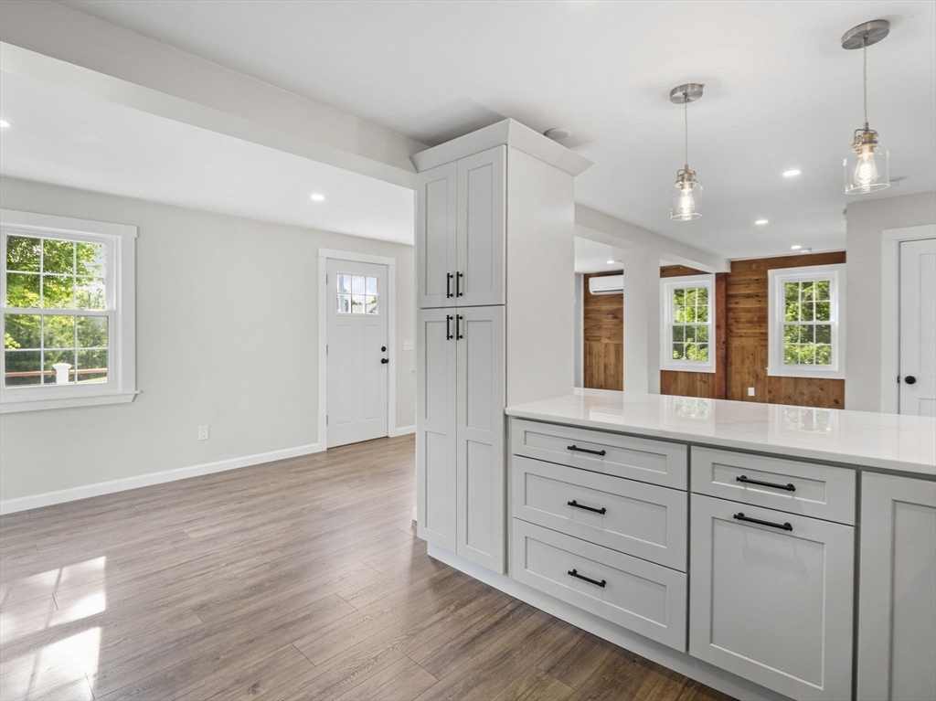210 John Dyer Road Little Compton, RI 02837 - Photo 9 of 42 a view of a kitchen island with wooden floor and windows