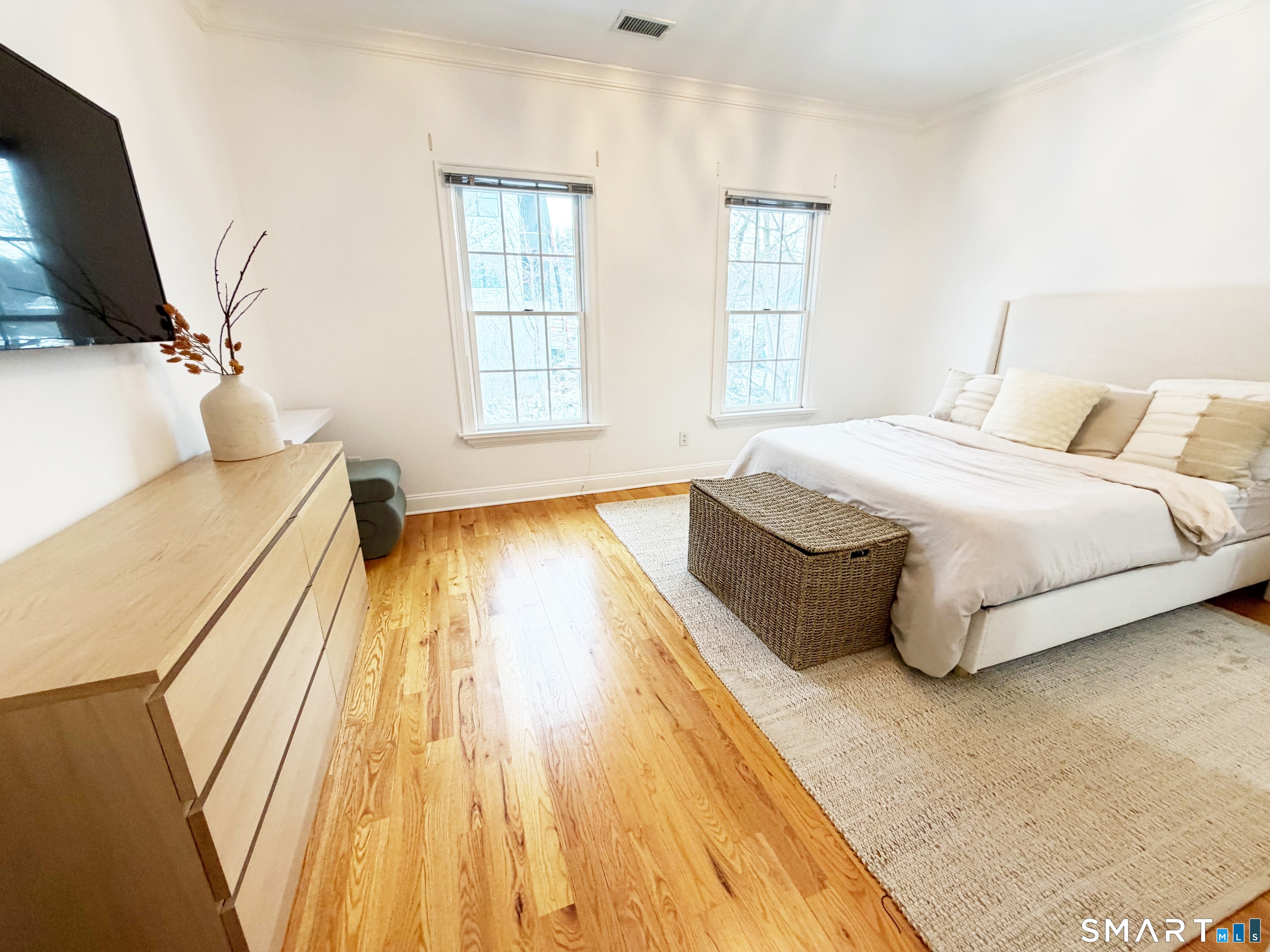 20 Cross Street, Unit 3 Westport, CT 06880 - Photo 15 of 20 a spacious bedroom with a bed and wooden floor