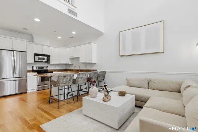 a living room with furniture and kitchen view
