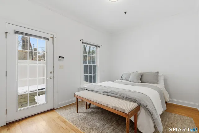 a bedroom with a bed and a window