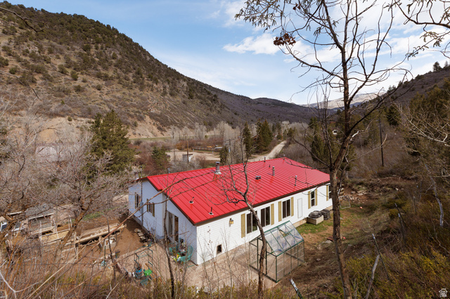 3902 Beaver Creek Road Kamas, UT 84036 - Photo 25 of 33 View of house with a metal roof, accessory building, greenhouse and a deck with mountain view