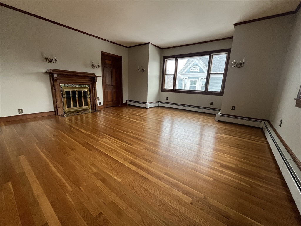 4 Gardner Street, Unit 2 Peabody, MA 01960 - Photo 11 of 13 an empty room with wooden floor and windows