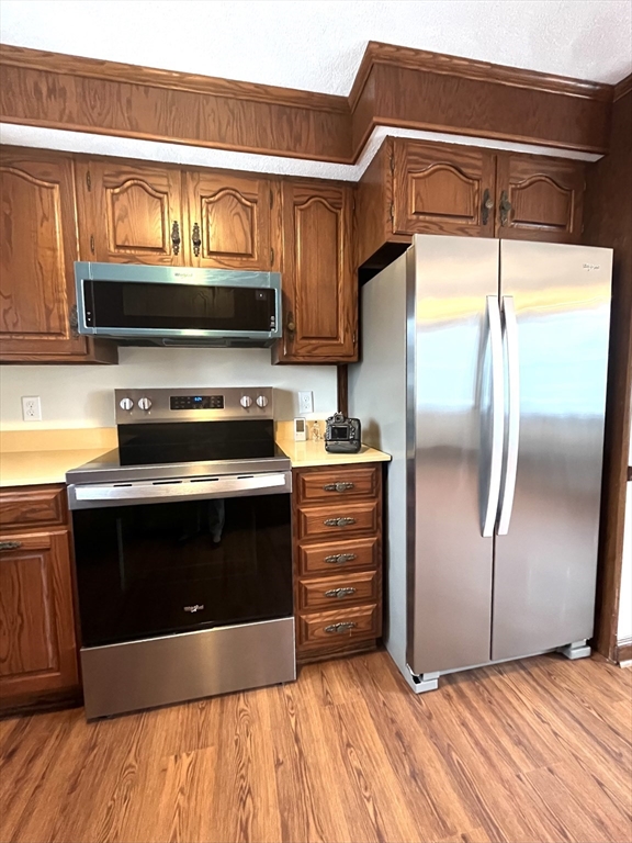 4 Gardner Street, Unit 2 Peabody, MA 01960 - Photo 3 of 13 a kitchen with granite countertop a refrigerator and a stove