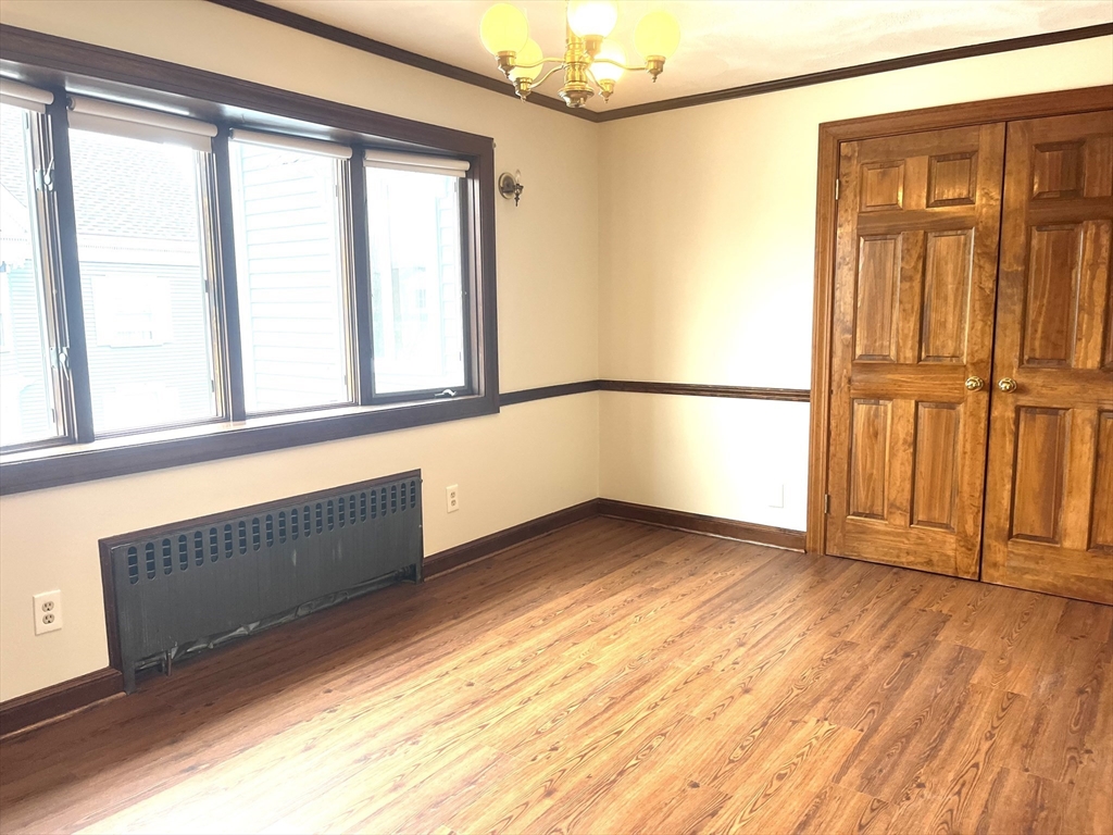 4 Gardner Street, Unit 2 Peabody, MA 01960 - Photo 4 of 13 a view of an empty room with a window and wooden floor