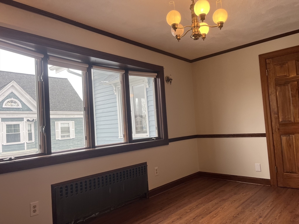 4 Gardner Street, Unit 2 Peabody, MA 01960 - Photo 6 of 13 a view of an empty room with a window and wooden floor