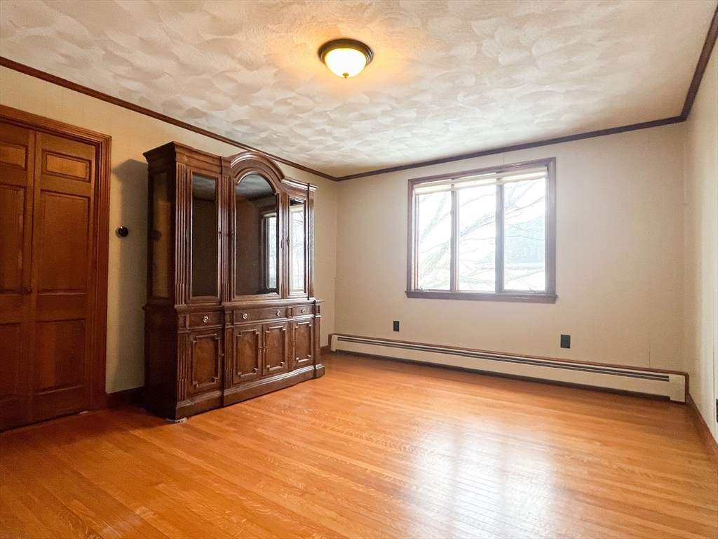 4 Gardner Street, Unit 2 Peabody, MA 01960 - Photo 7 of 13 an empty room with wooden floor and windows