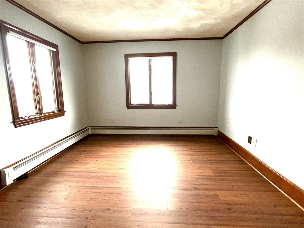 4 Gardner Street, Unit 2 Peabody, MA 01960 - Photo 8 of 13 an empty room with wooden floor and windows
