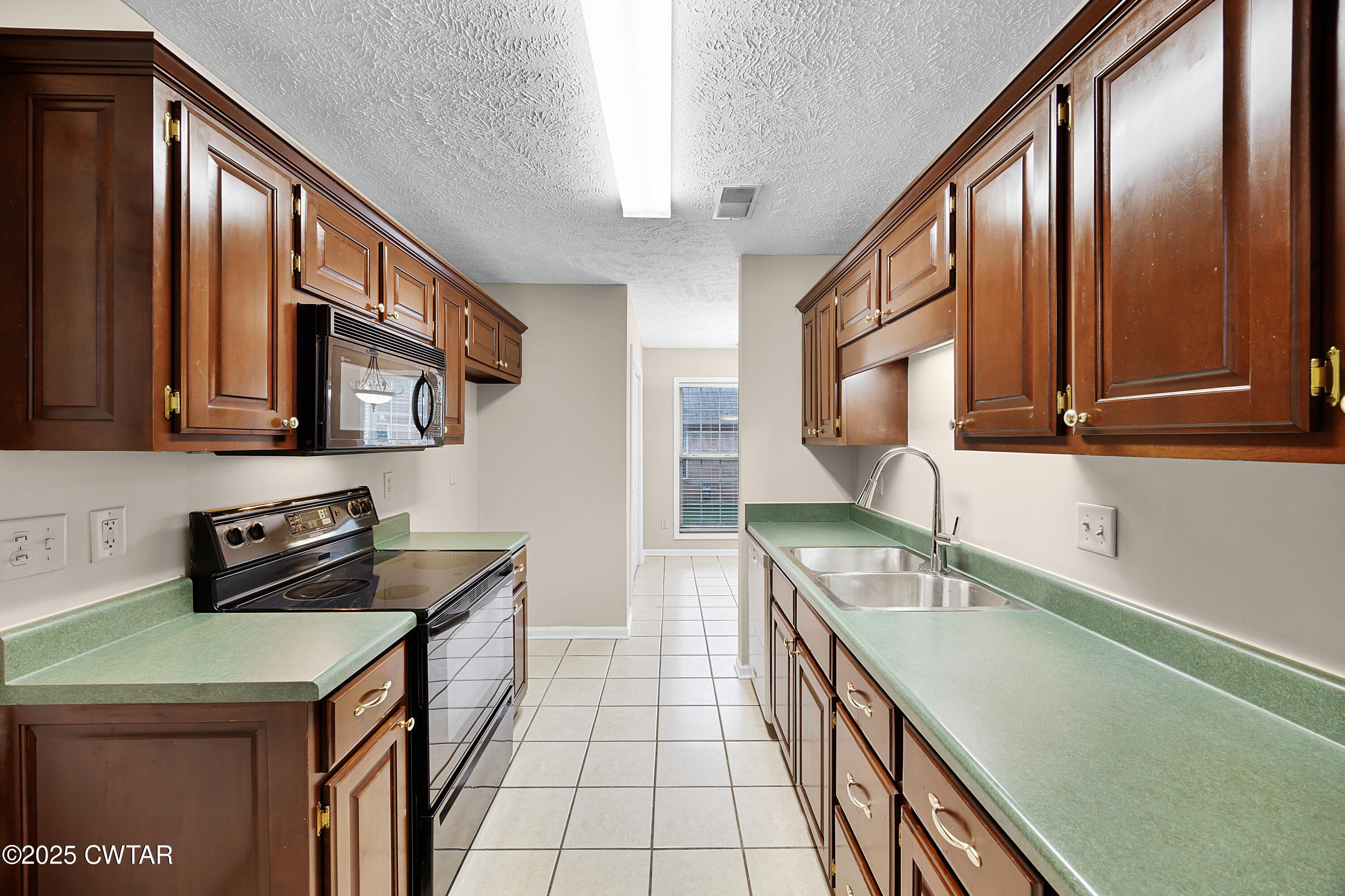98 Cotton Ridge Drive Jackson, TN 38305 - Photo 11 of 20 a kitchen with stainless steel appliances a sink stove and cabinets