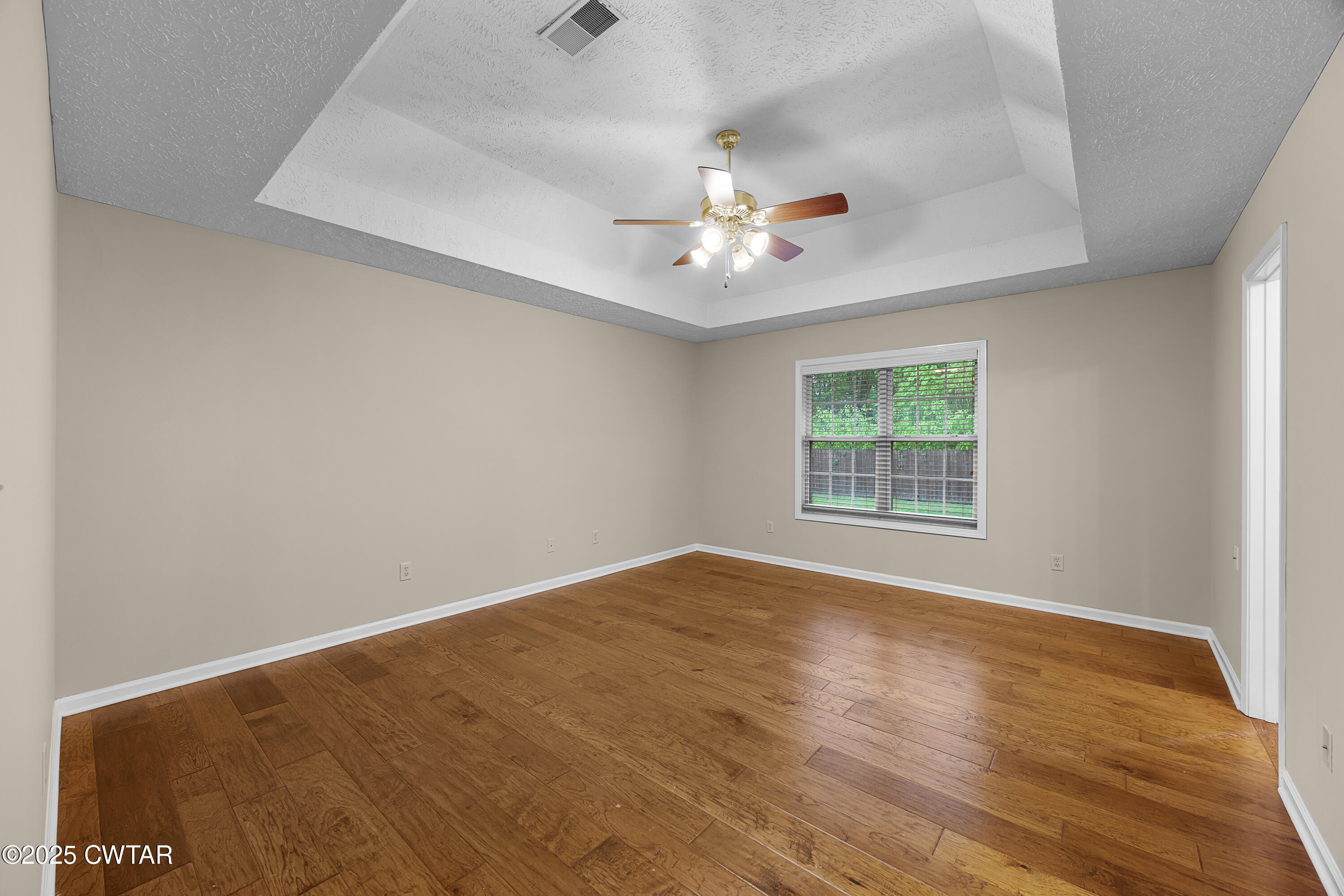 98 Cotton Ridge Drive Jackson, TN 38305 - Photo 16 of 20 an empty room with a window and a ceiling fan