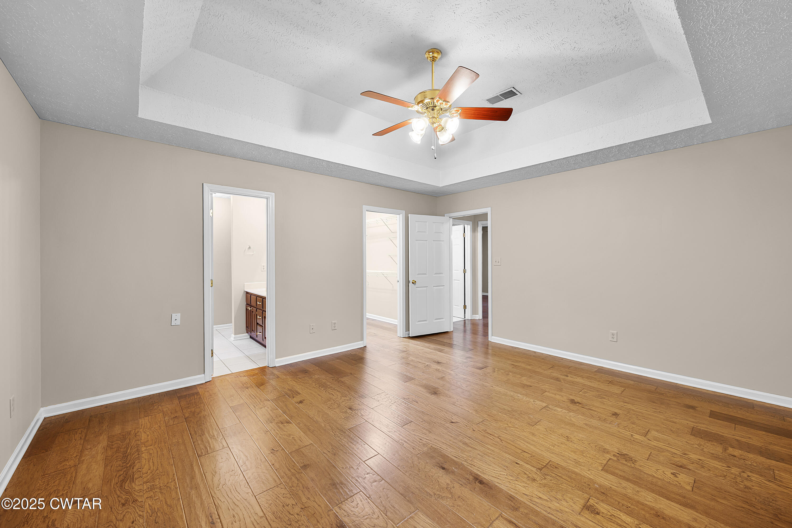 98 Cotton Ridge Drive Jackson, TN 38305 - Photo 17 of 20 a view of an empty room with wooden floor and a window