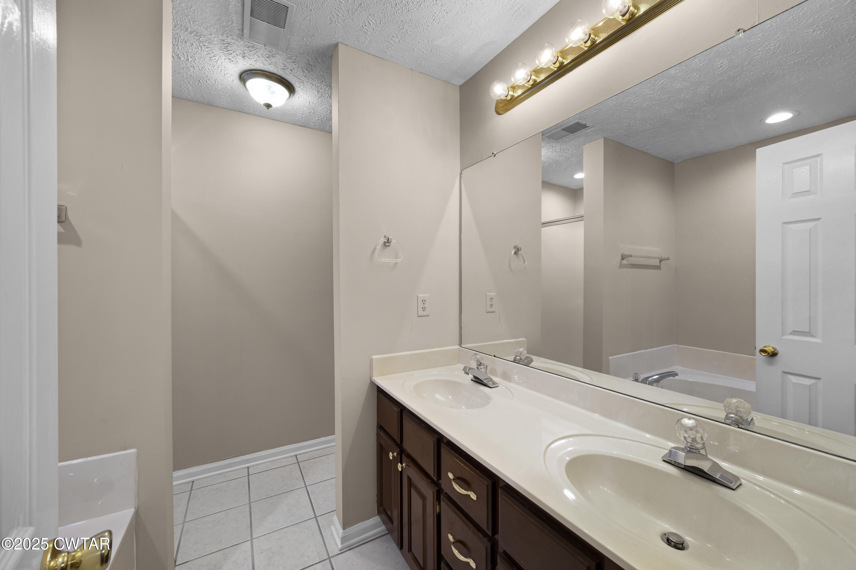 98 Cotton Ridge Drive Jackson, TN 38305 - Photo 19 of 20 a bathroom with a double vanity sink and a mirror