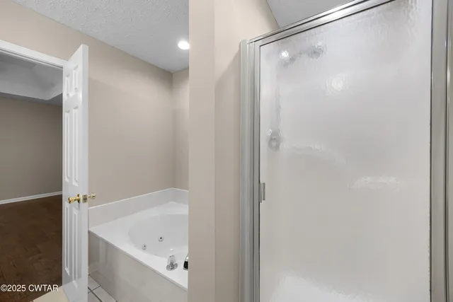 a bathroom with a bathtub and a shower