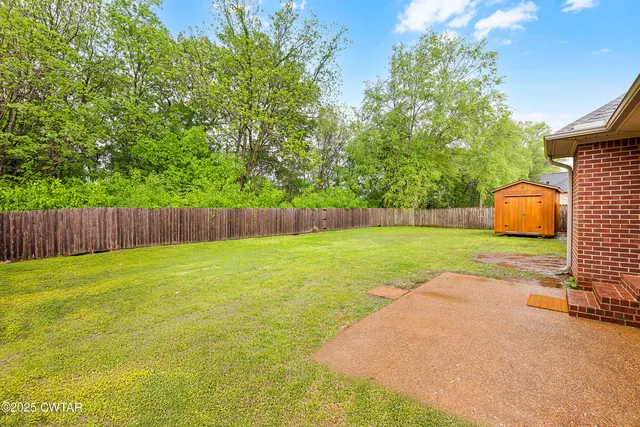 a view of a garden with wooden fence