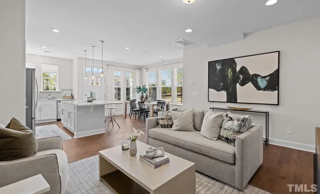 a living room with furniture and a view of kitchen