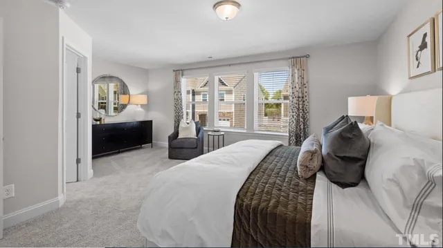 a bedroom with a bed and a large window