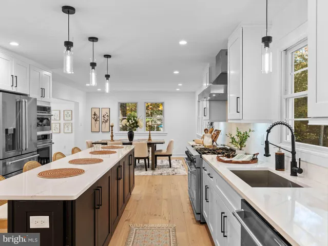 a kitchen with kitchen island a stove a sink and a refrigerator
