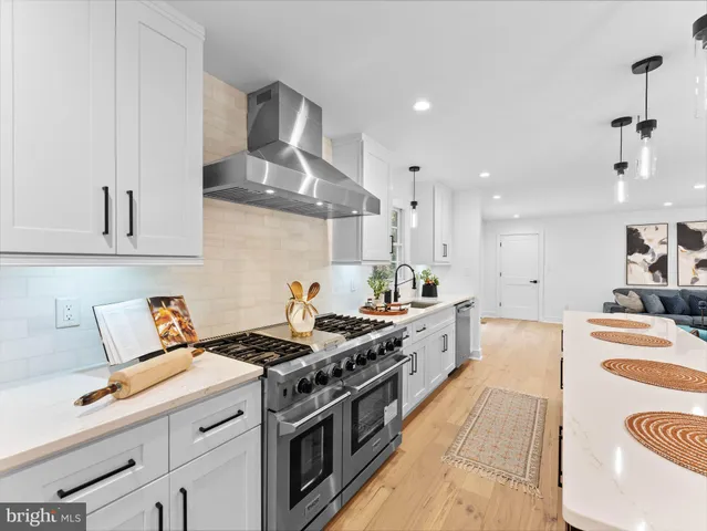 a kitchen that has a stove a table and chairs in it