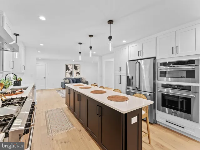 a view of a dining room with furniture a rug and wooden floor