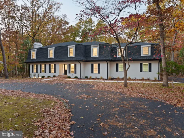a front view of a residential apartment building with a yard