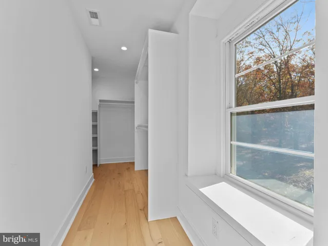 a view of an empty room and a ceiling fan