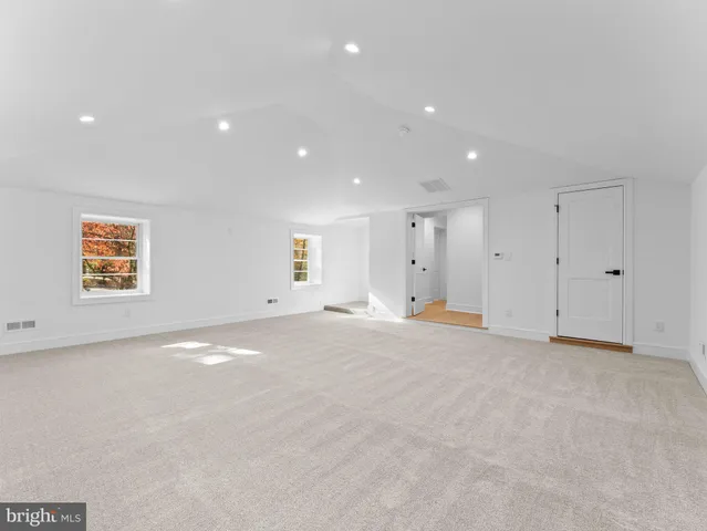 an empty room with a ceiling fan and a window