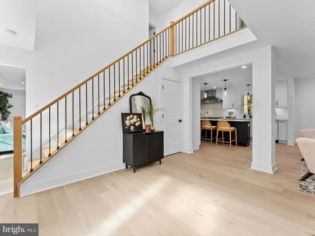 a view of entryway with wooden floor and stairs
