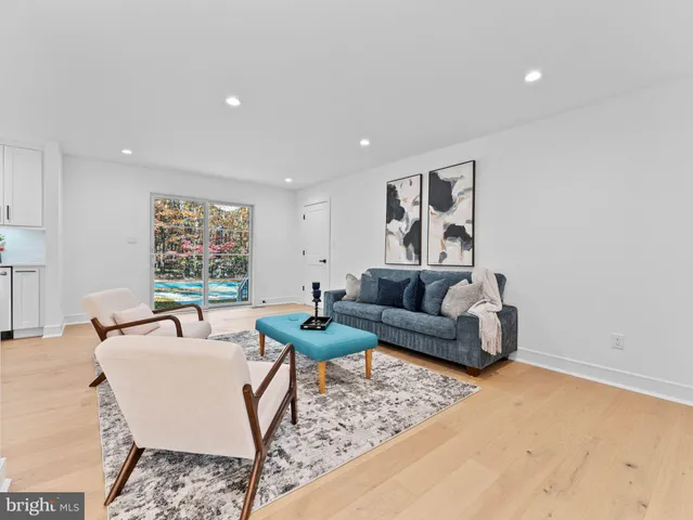 a living room with furniture and kitchen view