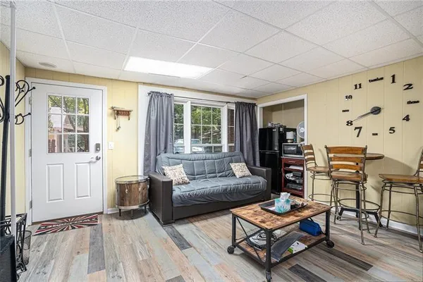 a living room with furniture a flat screen tv and a window