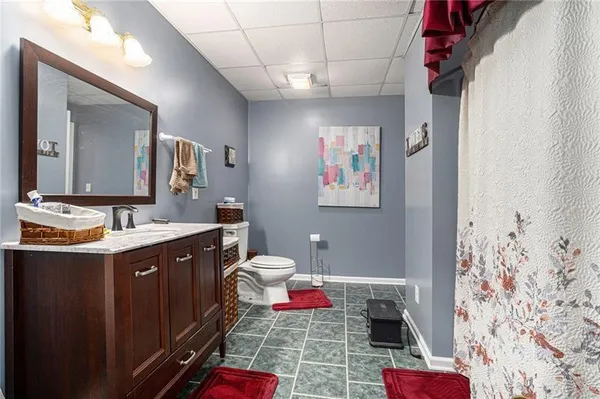 a bathroom with a sink mirror vanity and toilet