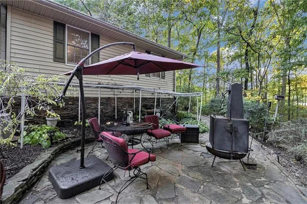 an outdoor sitting area with furniture and wooden deck