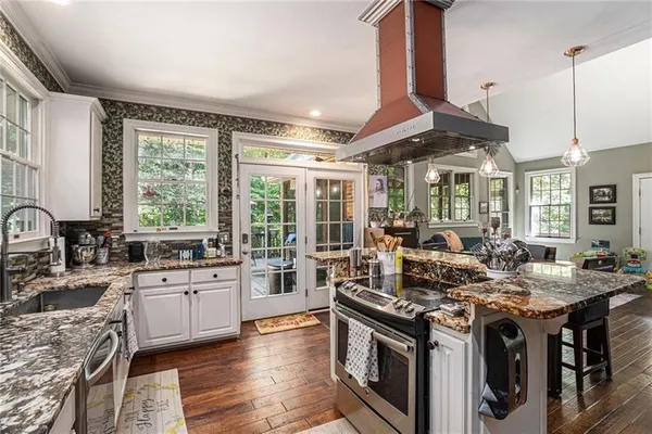a kitchen with stainless steel appliances granite countertop a stove and a sink