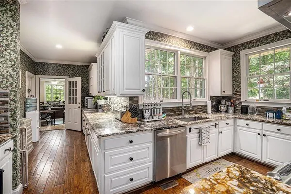 a kitchen with a sink window and cabinets