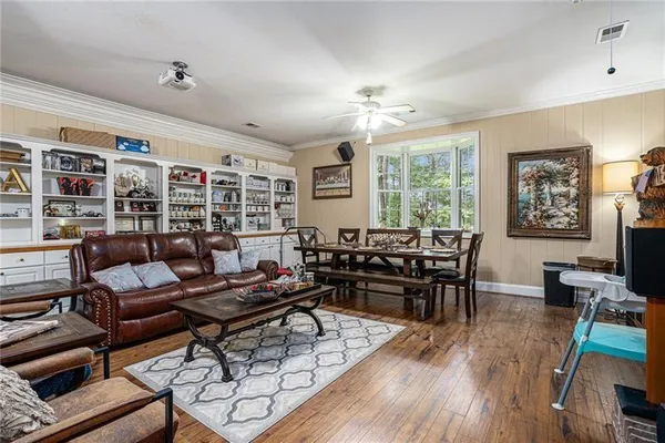 a living room with furniture or couch and a dining table