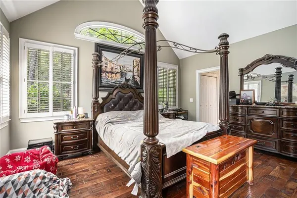 a bed room with a bed dresser and a window